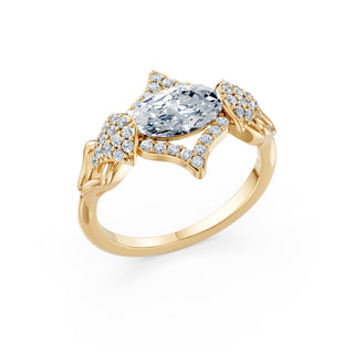 Colette ring in yellow gold, angled view showing the pavé wing shoulders